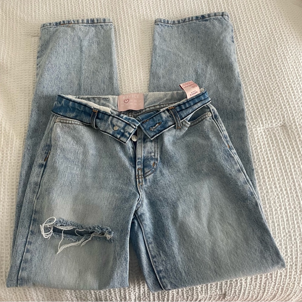 Revice denim Foldover waistband. Distressing in thigh and knee.